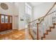Bright entryway featuring hardwood floors, a staircase, and a large window at 15573 E Prentice Ln, Centennial, CO 80015