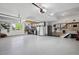 Well-organized three car garage with epoxied flooring, storage, and utility at 15573 E Prentice Ln, Centennial, CO 80015