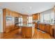Well-equipped kitchen with wood cabinets, stainless steel appliances, and a large center island at 15573 E Prentice Ln, Centennial, CO 80015