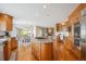 Open-concept kitchen with a central island, stainless steel appliances, and hardwood flooring at 15573 E Prentice Ln, Centennial, CO 80015