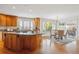Bright kitchen with wood cabinets, granite countertops, and access to an outdoor dining area at 15573 E Prentice Ln, Centennial, CO 80015