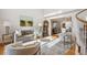 Sunlit living room with hardwood floors, a grandfather clock, and comfortable seating at 15573 E Prentice Ln, Centennial, CO 80015
