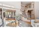 Bright living area featuring hardwood floors, a staircase, and views of the dining room at 15573 E Prentice Ln, Centennial, CO 80015