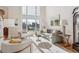 Bright living room with a high ceiling, large windows, and comfortable seating at 15573 E Prentice Ln, Centennial, CO 80015