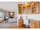 Living room with custom cabinets, granite countertops, and a view of the fireplace at 15573 E Prentice Ln, Centennial, CO 80015