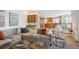 Cozy living room featuring hardwood floors, plush seating, and views of the open concept kitchen at 15573 E Prentice Ln, Centennial, CO 80015