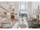 Sun-drenched living area boasting large windows and a staircase at 15573 E Prentice Ln, Centennial, CO 80015