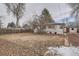 View of a home's backyard with mature trees, a lawn and a storage shed at 3361 S Dahlia St, Denver, CO 80222