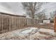 Backyard with a wood fence, mature trees and a small storage shed at 3361 S Dahlia St, Denver, CO 80222