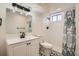 Updated basement bathroom with vanity, modern fixtures, tile floor, and shower at 3361 S Dahlia St, Denver, CO 80222