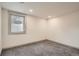 Basement room features neutral walls, carpet floors, and a window letting in natural light at 3361 S Dahlia St, Denver, CO 80222