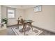 Basement office space features modern desk, gray carpet, and natural light from a window at 3361 S Dahlia St, Denver, CO 80222