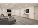 Staged basement with gray sofa, coffee table, console table, and fireplace under wall-mounted TV at 3361 S Dahlia St, Denver, CO 80222