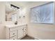 Bright bathroom with modern vanity, stylish fixtures, and a large mirror at 3361 S Dahlia St, Denver, CO 80222