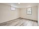 Bright bedroom with plank floors, two windows offering natural light, and neutral decor throughout at 3361 S Dahlia St, Denver, CO 80222