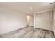 A spacious bedroom featuring neutral colors, hardwood floors, and a double door closet at 3361 S Dahlia St, Denver, CO 80222