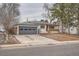 Charming single-story home featuring a gray garage door and a welcoming red front door at 3361 S Dahlia St, Denver, CO 80222