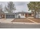 Charming single-story home featuring a gray garage door and a welcoming red front door at 3361 S Dahlia St, Denver, CO 80222