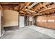 Exposed beam two car garage with a door to the side yard and an automatic garage door at 3361 S Dahlia St, Denver, CO 80222