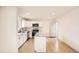 Bright kitchen with stainless steel appliances, granite counters, island, and white cabinets at 3361 S Dahlia St, Denver, CO 80222