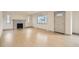 Bright living room featuring a decorative fireplace, large window, and light wood floors at 3361 S Dahlia St, Denver, CO 80222