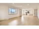 Bright living room flows into kitchen with hardwood floors and a large window at 3361 S Dahlia St, Denver, CO 80222