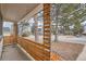 Covered front porch with a unique wood and metal railing at 3361 S Dahlia St, Denver, CO 80222