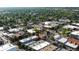 Aerial view of a vibrant commercial district surrounded by mature trees and convenient street parking at 6007 Yarrow St # D, Arvada, CO 80004