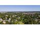 Expansive aerial view of the neighborhood, featuring lush greenery and a distant cityscape skyline at 6007 Yarrow St # D, Arvada, CO 80004