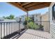 Private balcony with a wooden floor and black metal railing, perfect for relaxing outdoors at 6007 Yarrow St # D, Arvada, CO 80004