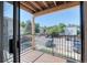 Enjoy the outside view from this balcony with wood flooring and black railings at 6007 Yarrow St # D, Arvada, CO 80004