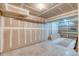 Unfinished basement ready for your design with shelving and concrete floor, ideal for storage at 6007 Yarrow St # D, Arvada, CO 80004