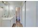 Bathroom features a single sink vanity and toilet with a view to an additional one at 6007 Yarrow St # D, Arvada, CO 80004