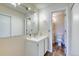 Bathroom features a single sink vanity and toilet with a view to an additional one at 6007 Yarrow St # D, Arvada, CO 80004