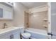 Bright bathroom featuring a shower-tub combo, single sink vanity, and neutral tiling at 6007 Yarrow St # D, Arvada, CO 80004