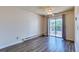 Bedroom featuring a ceiling fan, laminate flooring, and balcony access at 6007 Yarrow St # D, Arvada, CO 80004