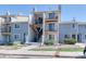 Exterior of a three-story condo featuring balconies with black iron railings and light gray painted siding at 6007 Yarrow St # D, Arvada, CO 80004