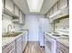 A bright and functional kitchen with white appliances, updated countertops, and ample cabinet space at 6007 Yarrow St # D, Arvada, CO 80004