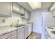 Efficient kitchen features light gray cabinetry and granite countertops at 6007 Yarrow St # D, Arvada, CO 80004