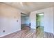 This airy living room has an open layout to kitchen, white walls, and wood-look floors at 6007 Yarrow St # D, Arvada, CO 80004