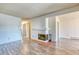 The living room has a fireplace, wood flooring, and white walls with two closets at 6007 Yarrow St # D, Arvada, CO 80004