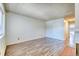 A spacious living room with white walls, wood flooring, and large windows for natural light at 6007 Yarrow St # D, Arvada, CO 80004
