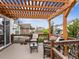 Inviting outdoor deck featuring a pergola, comfortable seating, and a tranquil atmosphere at 6308 Walnut Grove Way, Erie, CO 80516