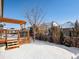 Expansive backyard including a wood deck with pergola, offering great outdoor enjoyment in winter at 6308 Walnut Grove Way, Erie, CO 80516