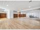 Spacious basement with modern plank flooring, wood accent wall, and recessed lighting at 6308 Walnut Grove Way, Erie, CO 80516