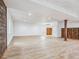 Spacious basement with modern plank flooring, wood accent wall, and recessed lighting at 6308 Walnut Grove Way, Erie, CO 80516