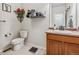 A cozy bathroom featuring a decorative shelf, granite counters, and tiled floors at 6308 Walnut Grove Way, Erie, CO 80516