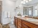 Spacious bathroom featuring double vanity, shower, decorative shelf, and tiled floor at 6308 Walnut Grove Way, Erie, CO 80516