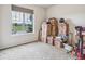 Neat bedroom with a large window and carpet floors at 6308 Walnut Grove Way, Erie, CO 80516