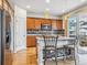 Modern kitchen featuring stainless steel appliances, granite countertops, and a breakfast bar at 6308 Walnut Grove Way, Erie, CO 80516